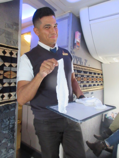 a man holding a tray with a towel