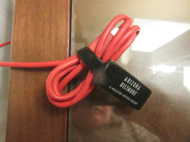 a red cable tied to a glass surface