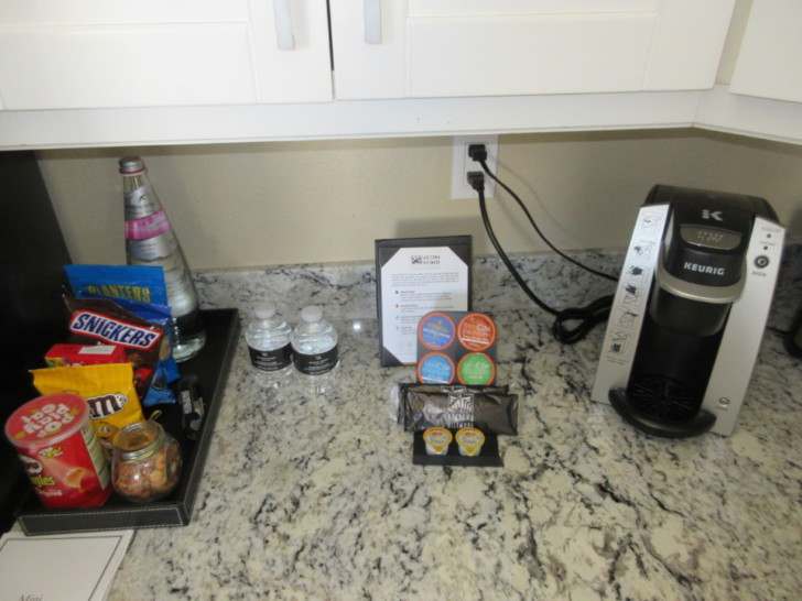 a coffee machine and snacks on a counter