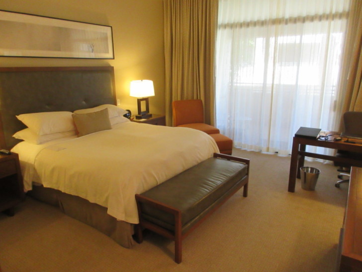 a bedroom with a bed and a chair