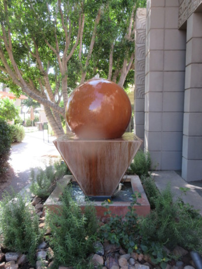 a large round ball on a stone pedestal