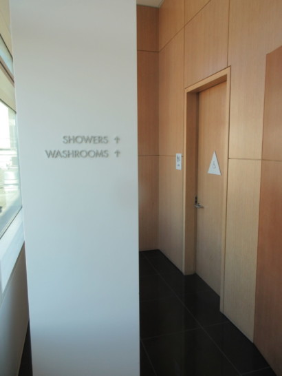 a bathroom with a sign and a door