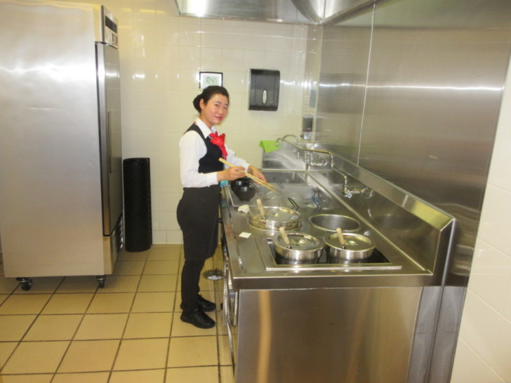 a woman standing in a kitchen
