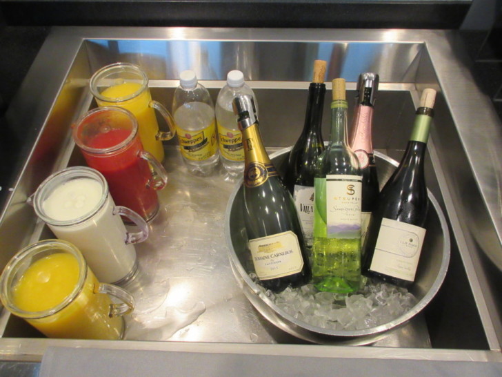 a sink full of bottles of alcohol and drinks