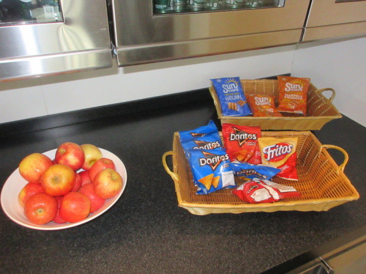 baskets of chips and apples on a counter