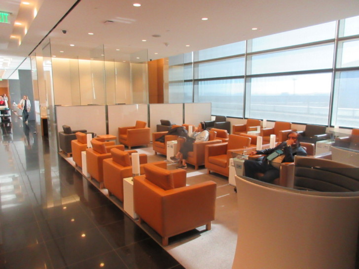 a group of people sitting in chairs in a lounge