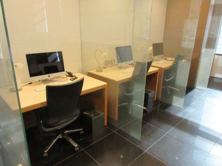 a room with computers and chairs