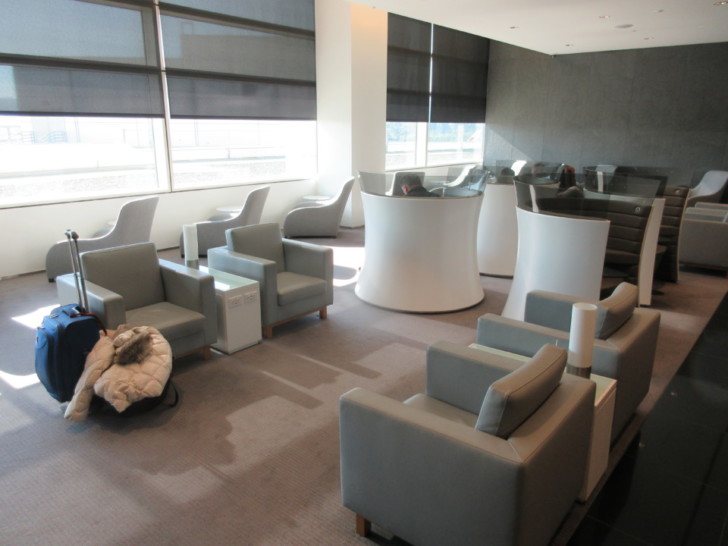 a room with a reception desk and chairs