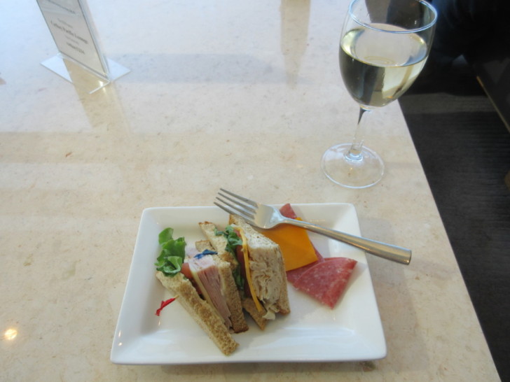 a plate of food and a glass of wine