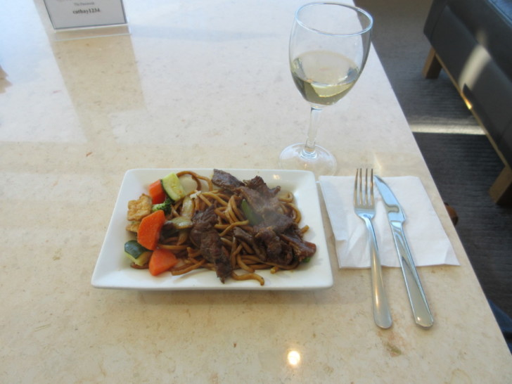 a plate of food and a glass of wine