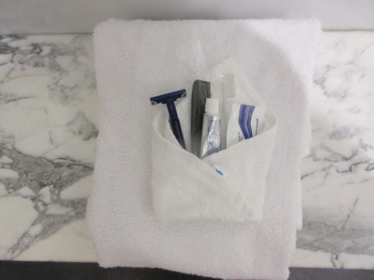 a towel with a razor and toothpaste