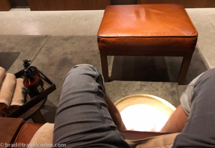 a person's legs in a round hole in a room