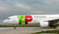 a white airplane with green and red text on it