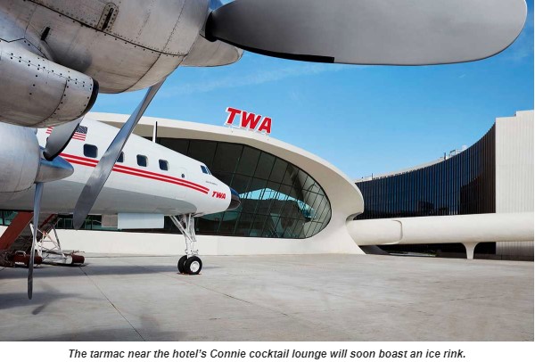 a plane parked outside of a building
