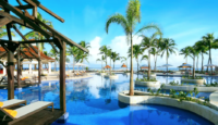 a pool with palm trees and umbrellas