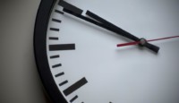 a clock with black and red hands