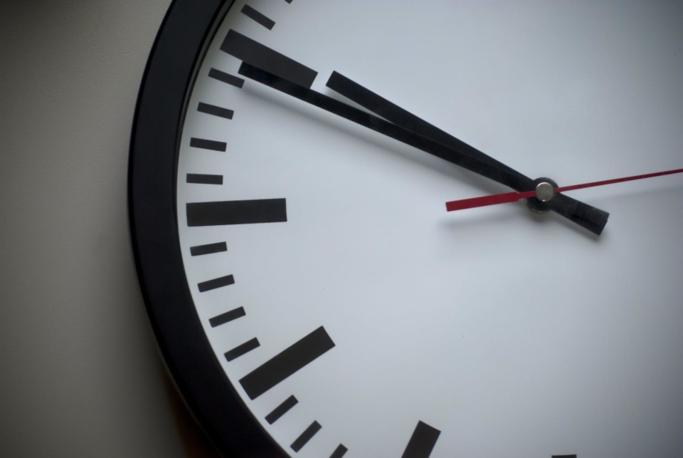 a clock with black and red hands