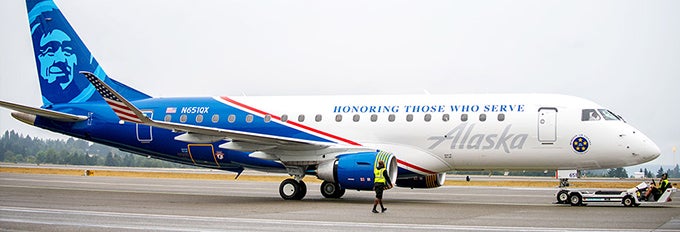 a man walking next to a plane