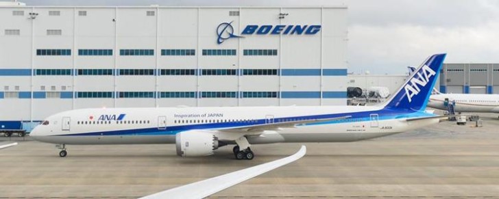 a plane parked in front of a building