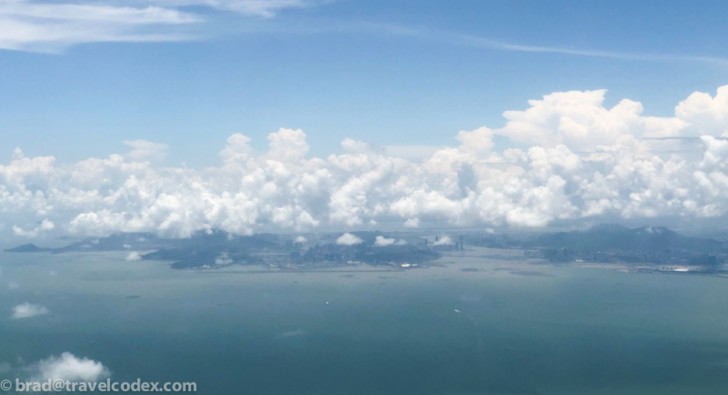 a body of water with clouds in the sky