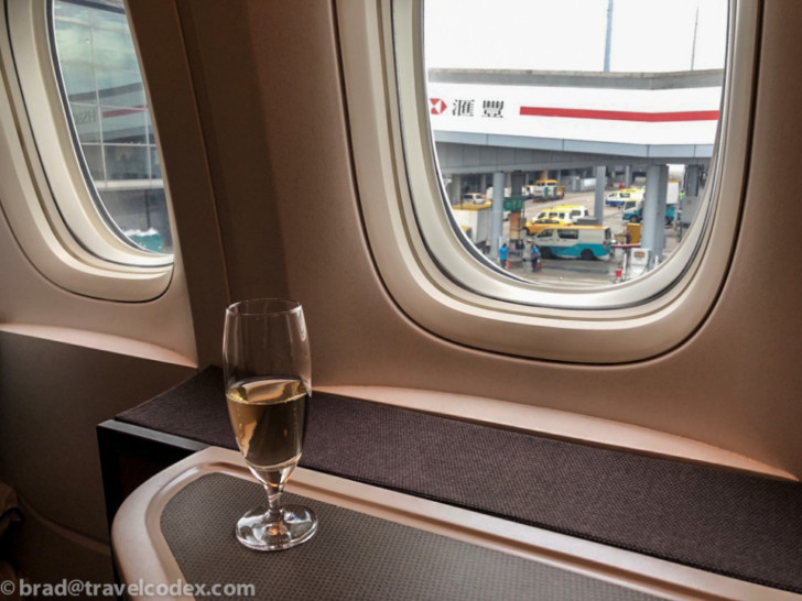 a glass of wine on a table in a plane