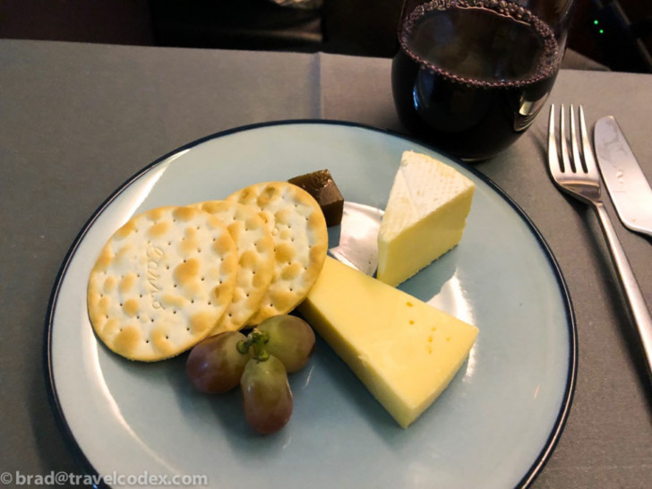 a plate of cheese grapes and crackers