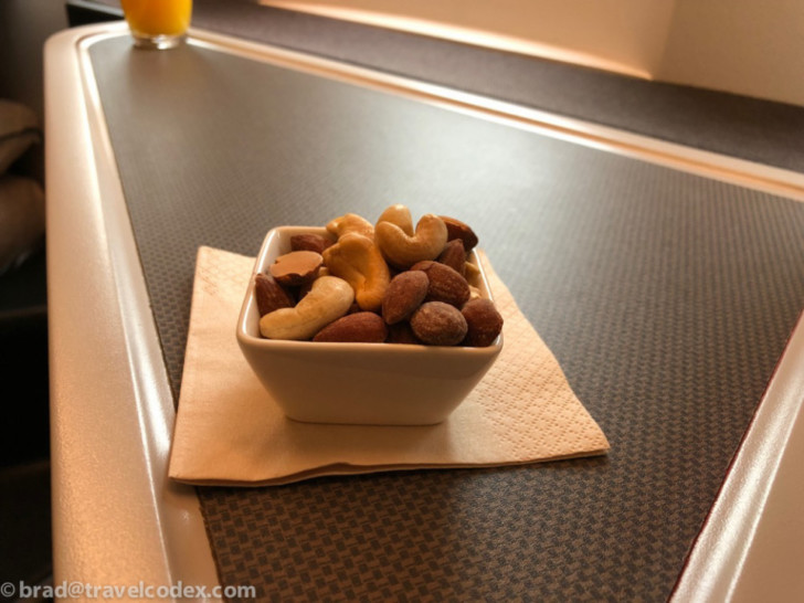 a bowl of nuts on a napkin