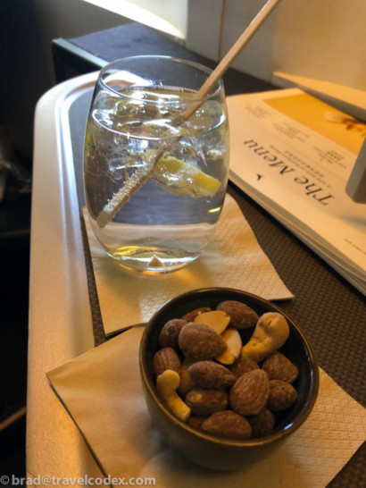 a bowl of nuts and a glass of water