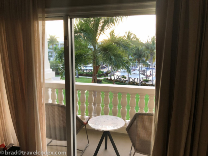 a balcony with a table and chairs