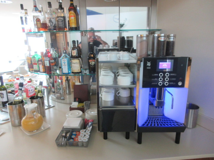 a coffee machine and bottles on a counter