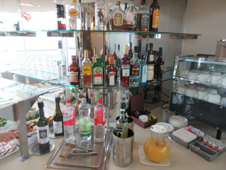 a shelf with bottles of alcohol