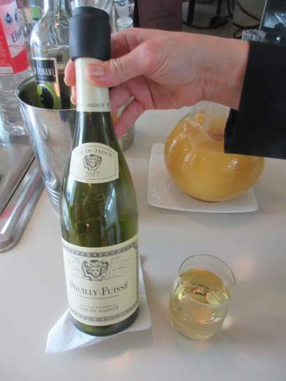 a hand holding a bottle of wine