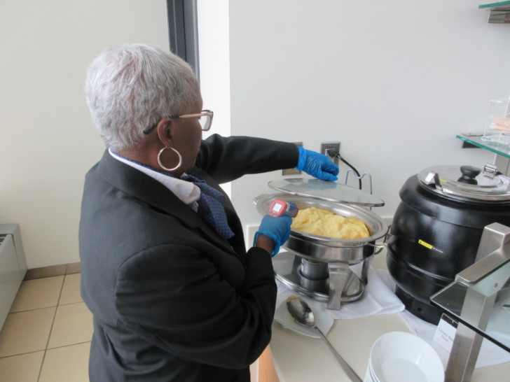 a woman in a suit holding a barcode scanner