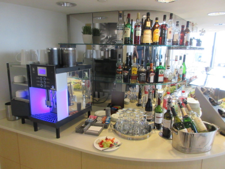 a bar with bottles of alcohol on shelves