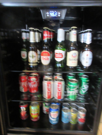 a refrigerator full of beer and cans