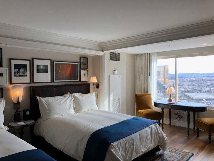 a bedroom with a desk and a bed