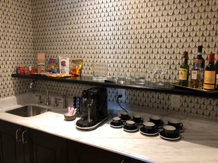 a kitchen counter with a black and white wallpaper