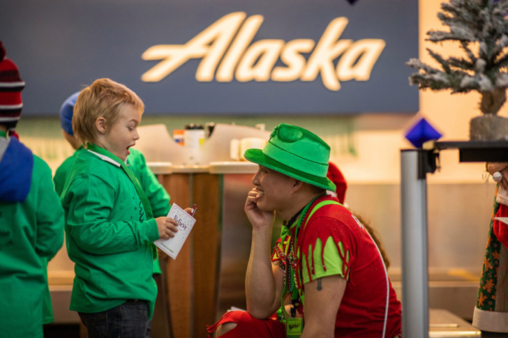 a man in a green hat and green hat with a child in a green shirt
