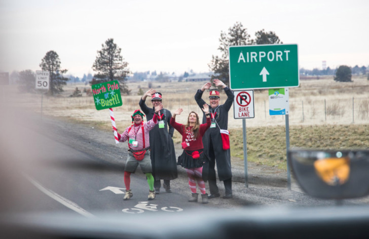 a group of people in clothing standing on the side of a road