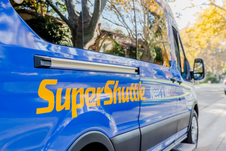 a blue van with yellow writing on it