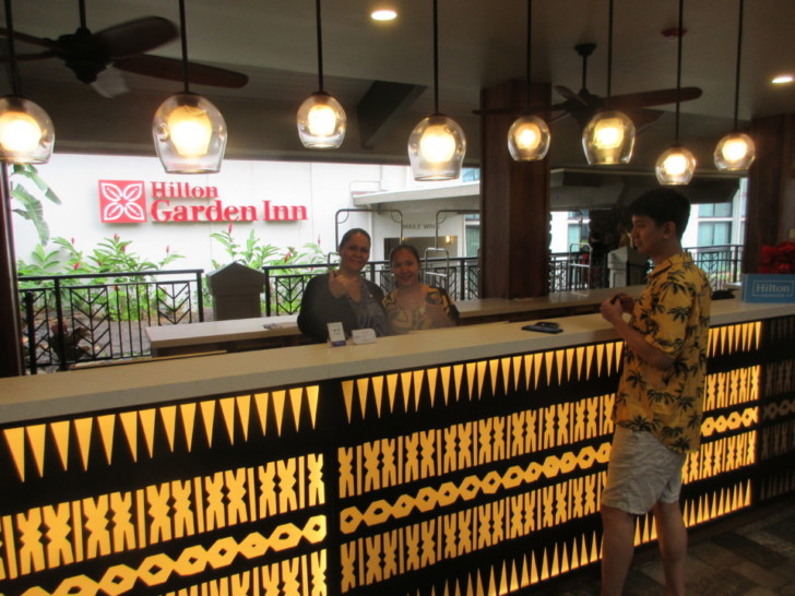 a group of people standing at a reception desk