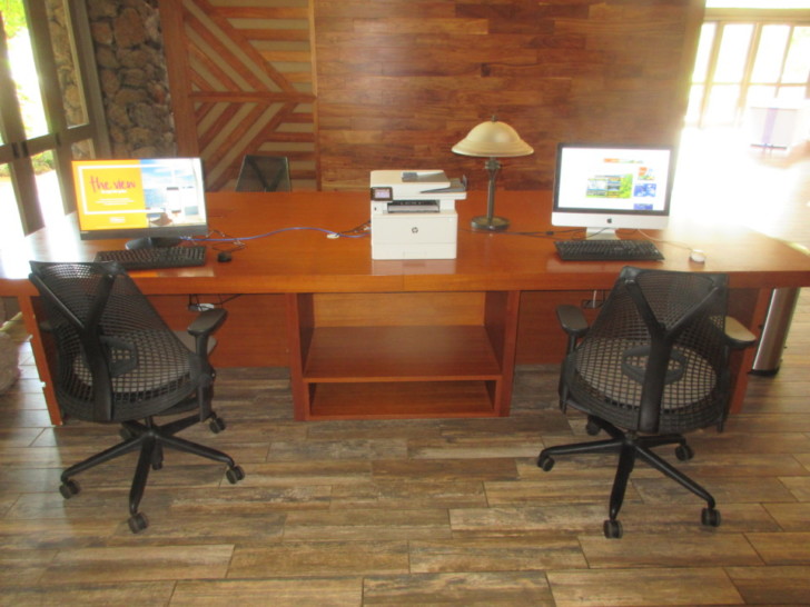 a desk with two computers on it