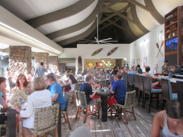 a group of people sitting at tables in a restaurant