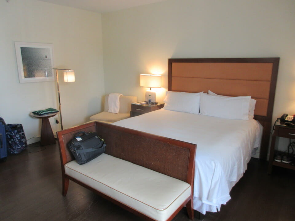 a bed with a couch and a bag on it