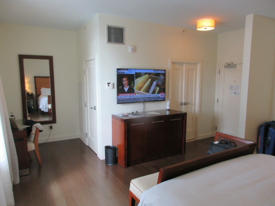 a room with a television and a mirror
