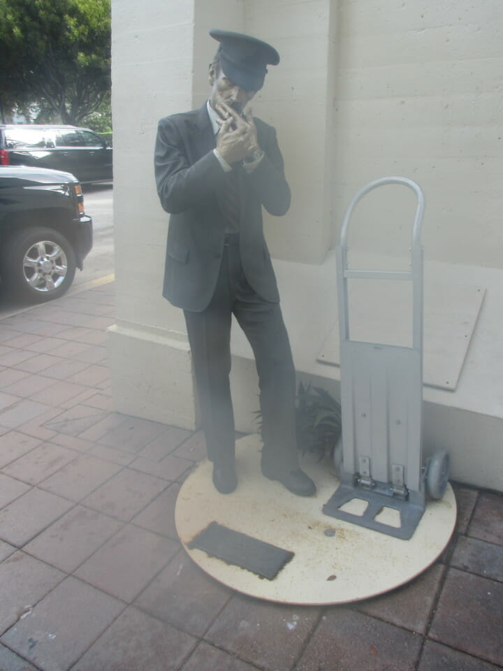 a man in a suit smoking a cigarette
