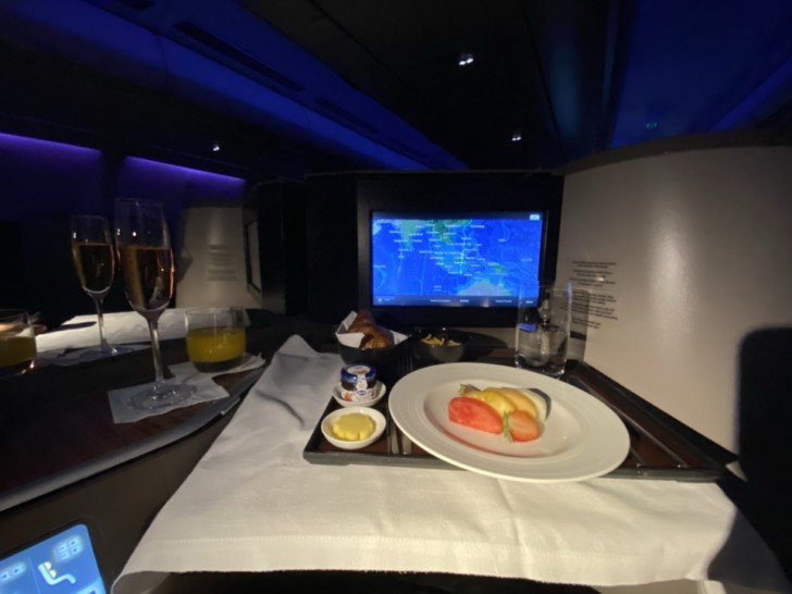 a tray with food and drinks on it in a room with a computer