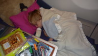 a child sleeping on a bed