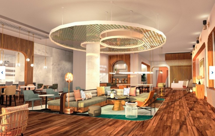 a room with a large sofa and tables