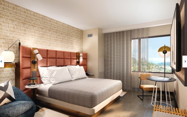a bedroom with a bed and a table